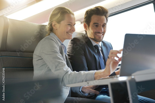 two colleagues working on a train