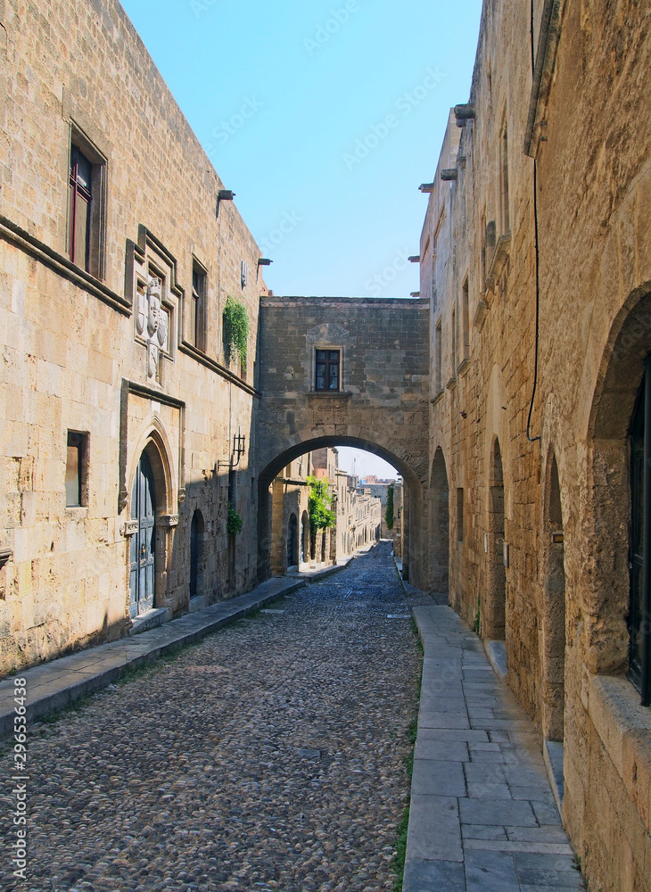 view of the street of the knights of rhodes lined with medieval buildings and an archway joining buildings