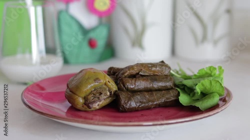 Traditional Turkish foods, dolma and sarma. Pouring ayran into glass.