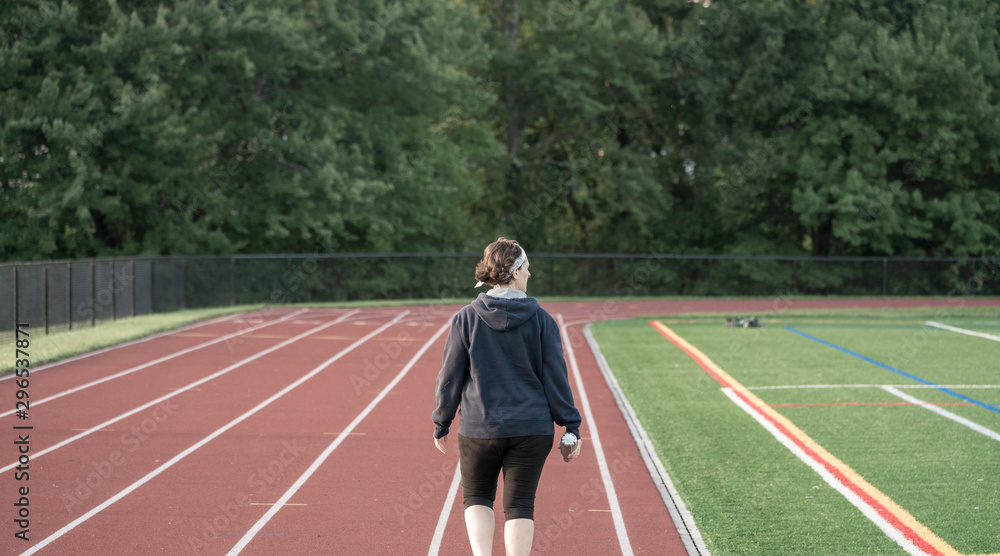 Middle age woman staying fit on track Middle age woman staying fit on track