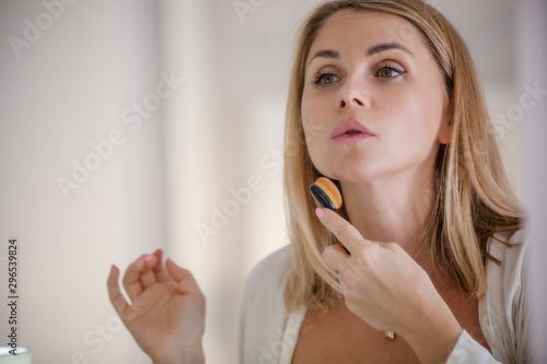 woman looking at a mirror