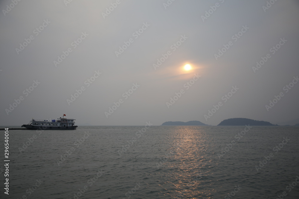 Sunset in a harbor of Bai Tu Long Bay, Vietnam