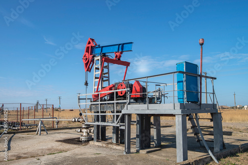 Working pump jack fracking crude extraction machine photo