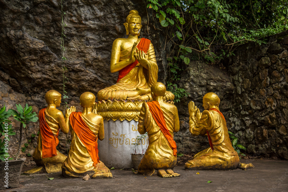 Luang Prabang, Laos »; August 2017: A sculpture of seated Buddha and people praying on the mount of That Pousy in Luang Prabang Luang Prabang, Laos »; August 2017: A sculpture of seated Buddha and people praying on the mount of That Pousy in Luang Prabang