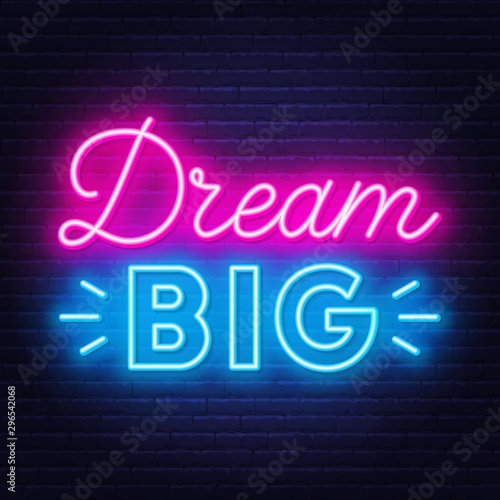 Neon lettering dream big on dark background .