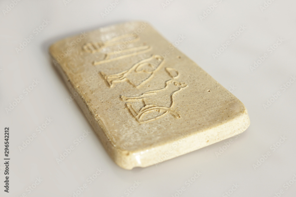 Fototapeta premium clay tablet with the inscription cat in ancient egyptian. modern handwork. hieroglyph cat