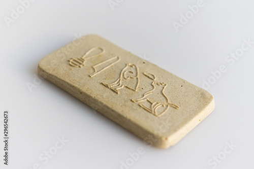 clay tablet with the inscription cat in ancient egyptian. modern handwork. hieroglyph cat