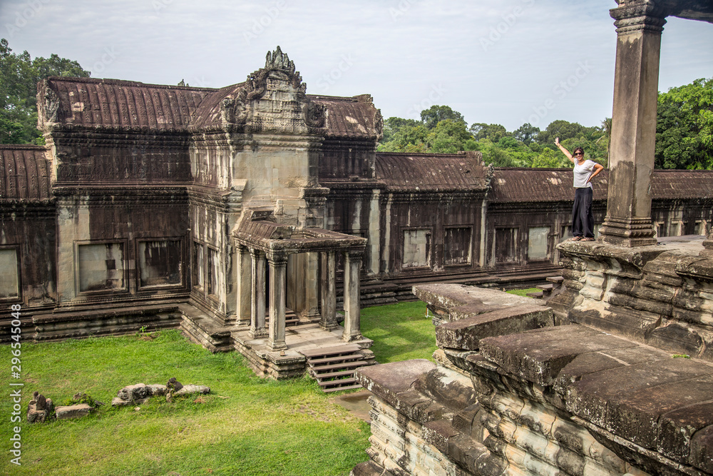 Angkor Wat, Siem Reap »; August 2018: A young woman in a white T-shirt atop an Angkor Wat temple