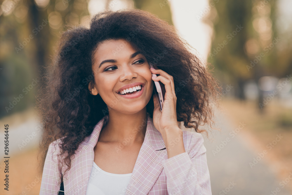 Closeup photo of amazing pretty dark skin lady spending time walk park after university lectures hold telephone speak best friend fall warm weather wear jacket outdoors Closeup photo of amazing pretty dark skin lady spending time walk park after university lectures hold telephone speak best friend fall warm weather wear jacket outdoors