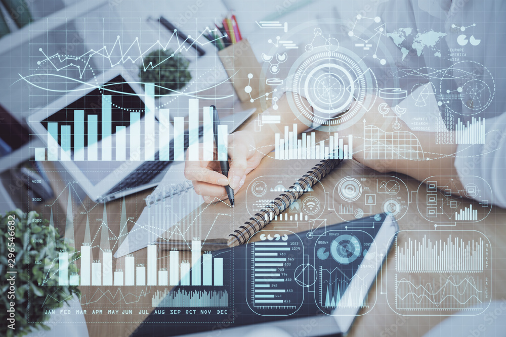 Financial graph displayed on woman's hand taking notes background. Concept of research. Double exposure Financial graph displayed on woman's hand taking notes background. Concept of research. Double exposure