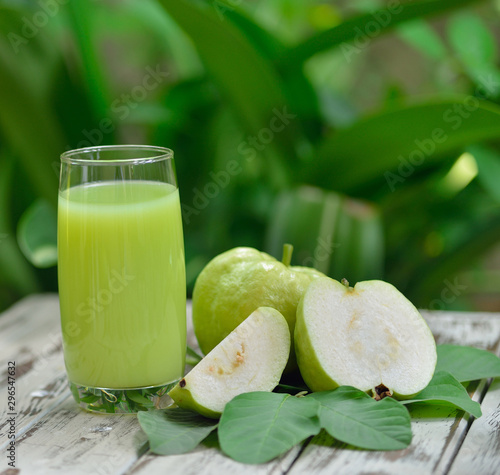 Guava juice and fresh Guava on wooden background