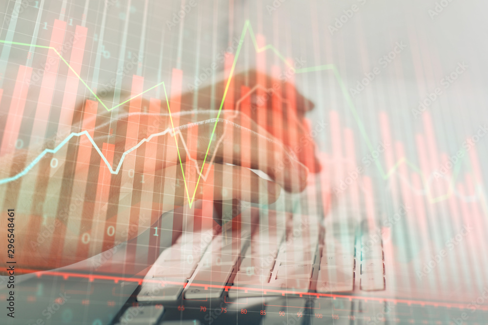 Double exposure of graph with man typing on computer in office on background. Concept of hard work. Closeup. Double exposure of graph with man typing on computer in office on background. Concept of hard work. Closeup.