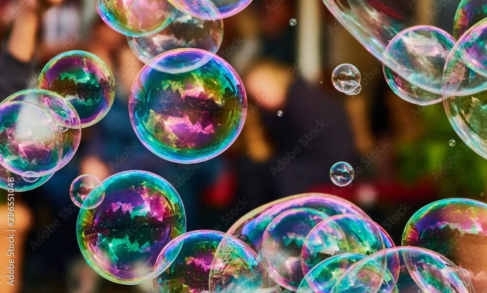 Metallic glowing colorful soap bubble in the in of a blurry background Stock Photo | Stock