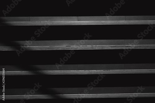 black and white staircase with light and shadow from window
