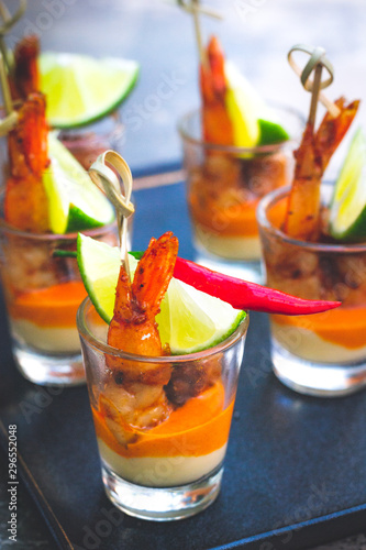 Shrimp Skewer in Creole sauce and cream cheesw sauce and lime wedge served in a shot glass photo