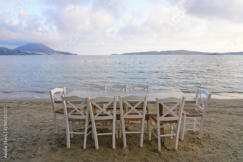 Table set on the beach at a traditional Greek taverna in Gialova on the Navarino Bay in Messinia in the Peloponnese region of Greece near Pylos © eqroy
