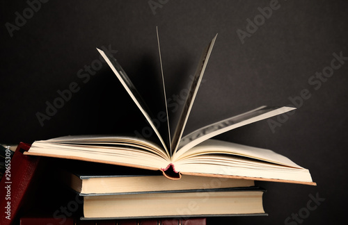 Different old hardcover books against black background