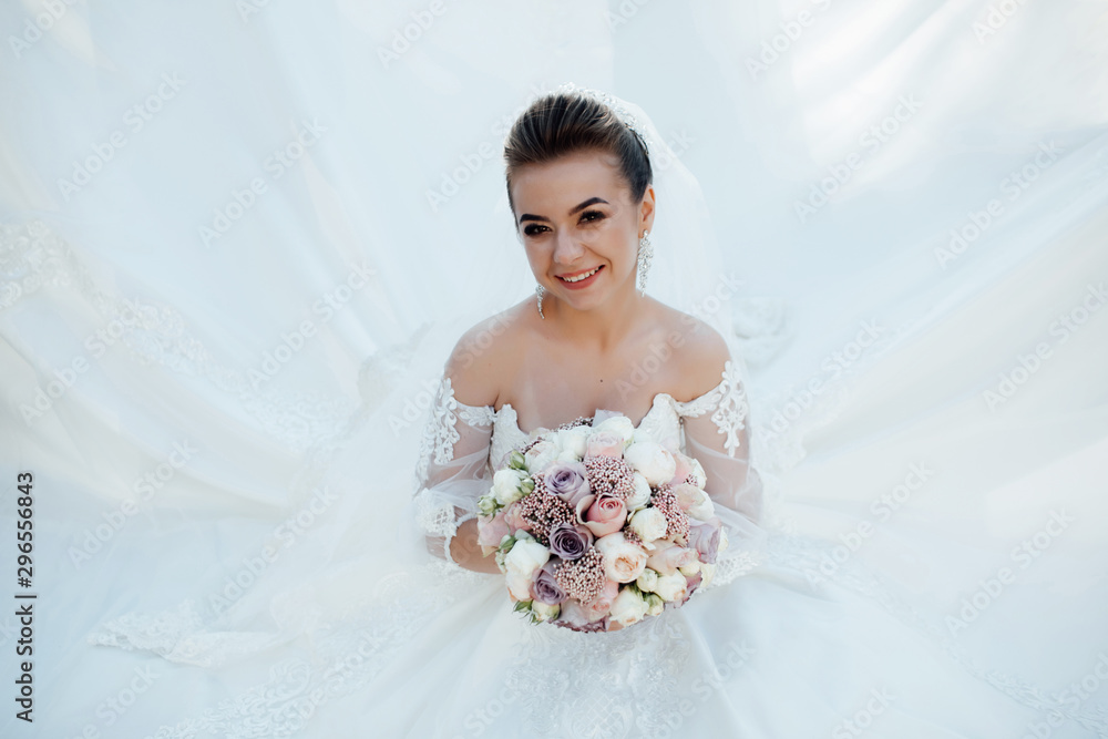 Smiling beautiful young bride. Fashion, beauty, style. Beauty portrait of bride. Beautiful bride with make up and hairstyle. Young attractive bride with bouquet of flowers. Smiling beautiful young bride. Fashion, beauty, style. Beauty portrait of bride. Beautiful bride with make up and hairstyle. Young attractive bride with bouquet of flowers.