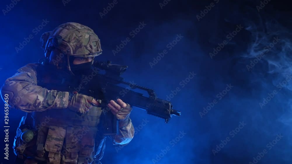 a man in a military uniform with a weapon in his hands a man in a military uniform with a weapon in his hands