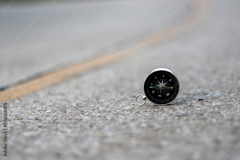 A compass on road texture background, journey of life concept A compass on road texture background, journey of life concept