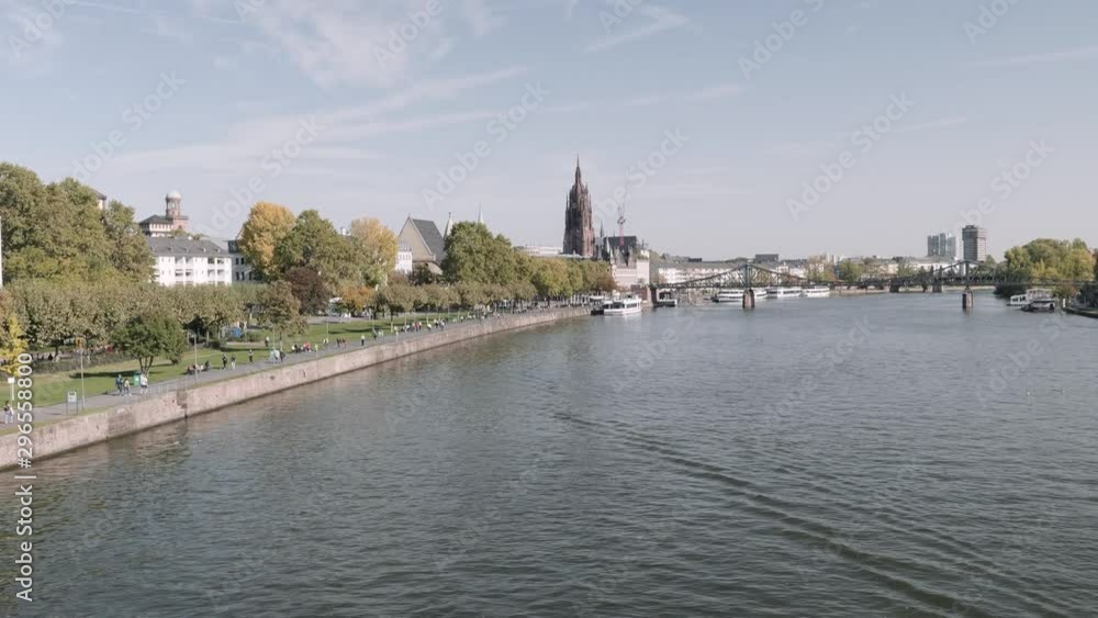 Panoramic view of Frankfurt main river with park, buildings and bridge as background during daytime Panoramic view of Frankfurt main river with park, buildings and bridge as background during daytime