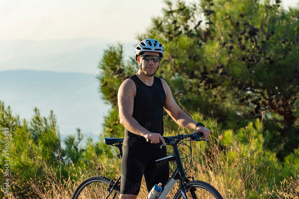 Fototapeta premium Male cyclist standing with his bike