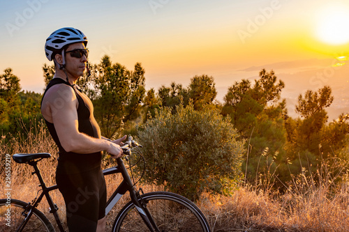 Male biker watching the sunset