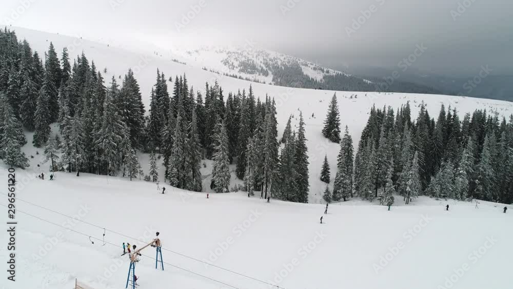 Fly over mountain slope with skiers Fly over mountain slope with skiers