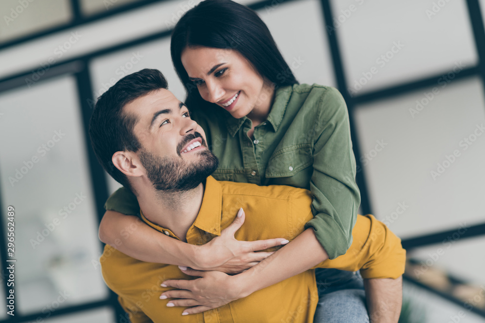 Closeup photo of handsome husband guy and his wife lady spending honeymoon in modern luxury country penthouse flat holding piggyback wear casual clothes Closeup photo of handsome husband guy and his wife lady spending honeymoon in modern luxury country penthouse flat holding piggyback wear casual clothes