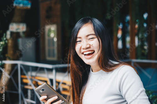 Business asian women use cellphone sitiing in coffee shop photo