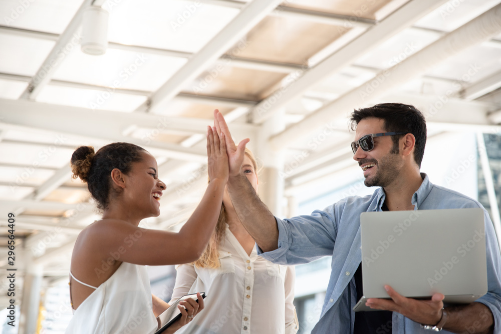 Obraz premium Low Angle View Of Business People Giving High Five In City