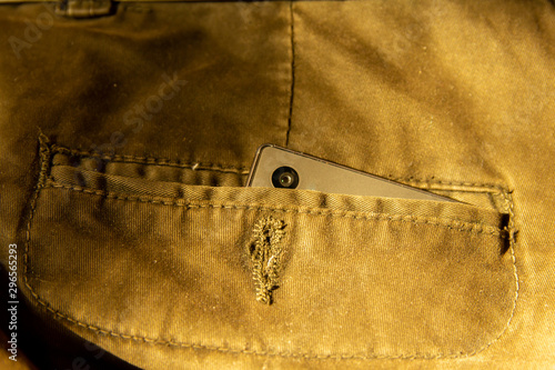 Modern smartphone in jeans pocket