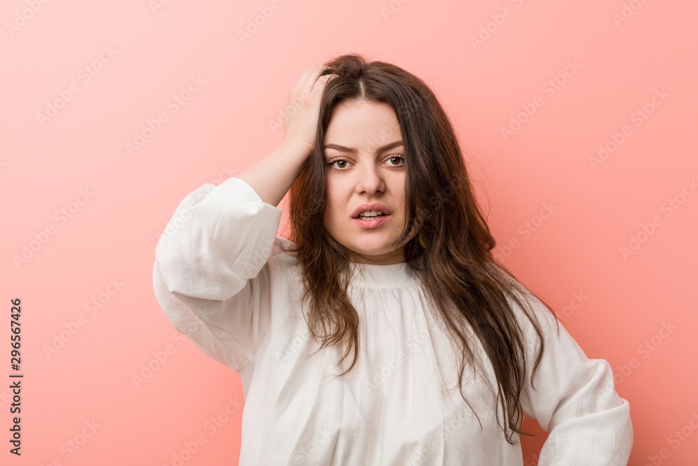Young caucasian curvy woman standing against pink background Young caucasian curvy woman standing against pink background