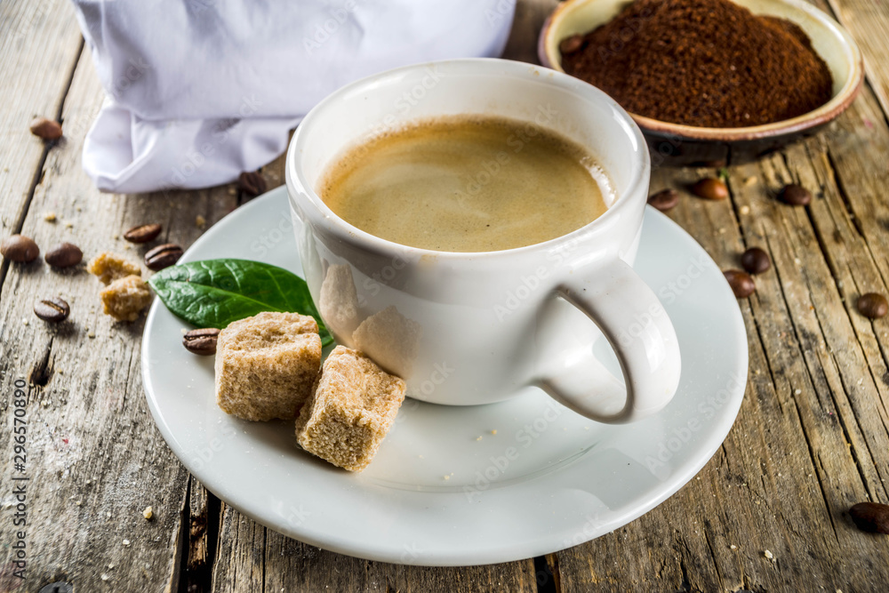 Cup of espresso with coffee beans. ground coffee and leaves on rustic background Cup of espresso with coffee beans. ground coffee and leaves on rustic background