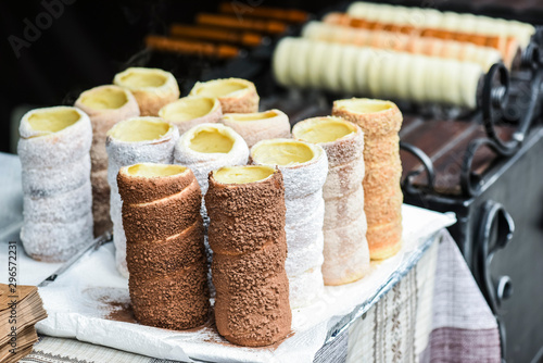 Trdelnik or trdlo is traditional czech sweet hollow roll pastry dough sell on market place. photo