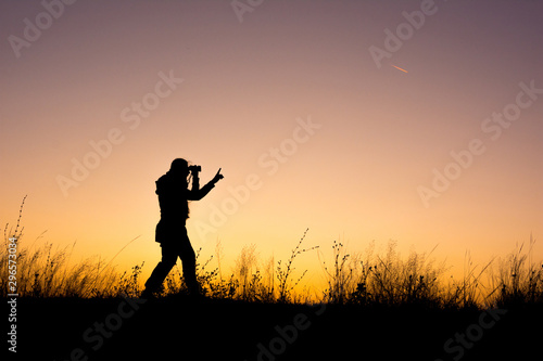 Young girl silhouette looking through binoculars © Mihai