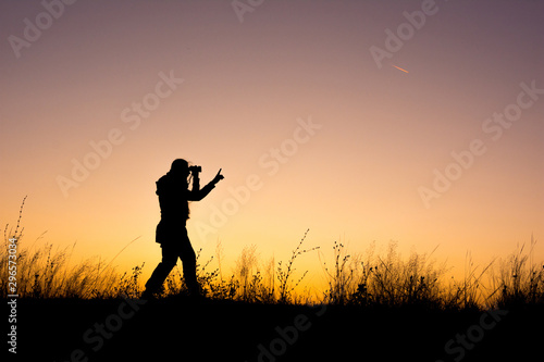 Young girl silhouette looking through binoculars