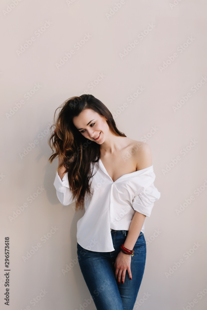 portrait of a young beautiful woman with dark hair. Beautiful young brunette posing in the studio. Romantic shot portrait of a young beautiful woman with dark hair. Beautiful young brunette posing in the studio. Romantic shot