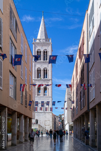 Cathedral church bell in Zadar Croatia. Festive streets of Zadar Croatia. Festive flags hanging on the street.