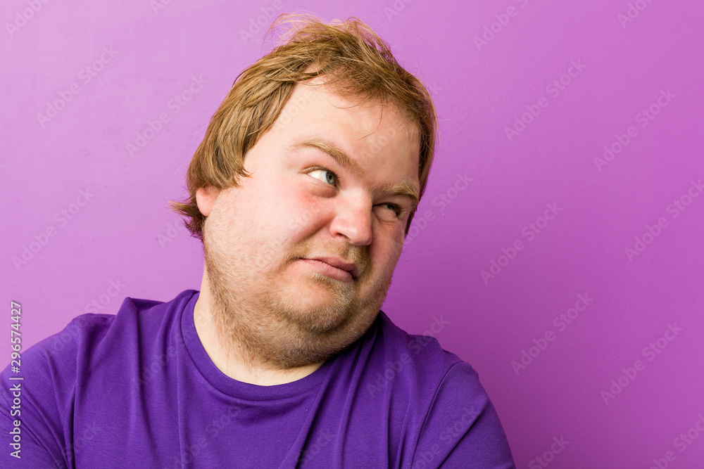 Young authentic redhead fat man confused, feels doubtful and unsure. Young authentic redhead fat man confused, feels doubtful and unsure.