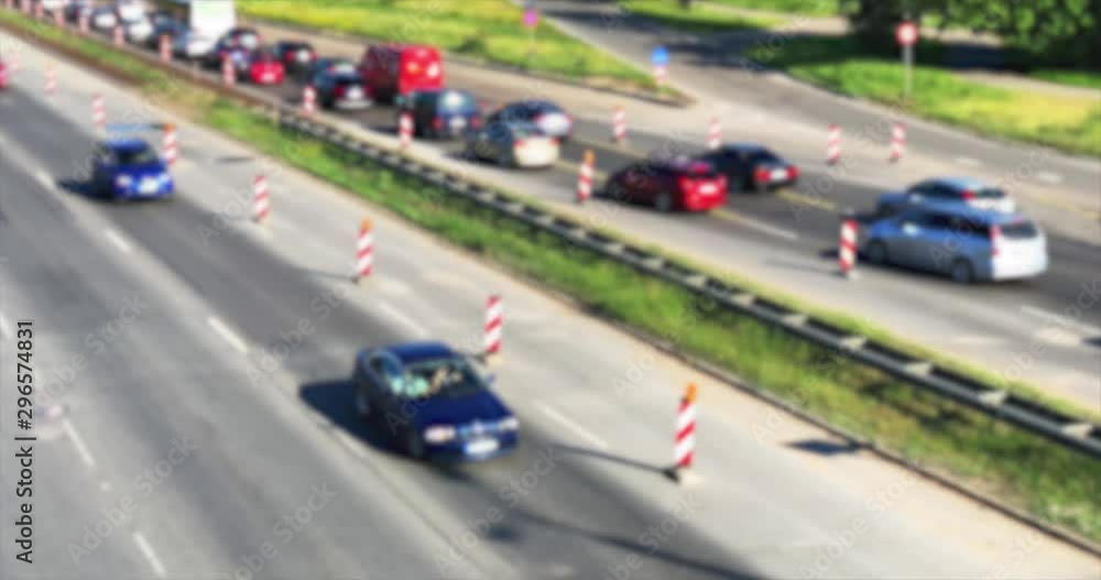 Roadwork cones managing the traffic flow. Traffic jam out of focus. Roadwork cones managing the traffic flow. Traffic jam out of focus.