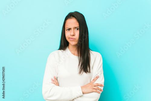 Young pretty hispanic woman unhappy looking in camera with sarcastic expression.