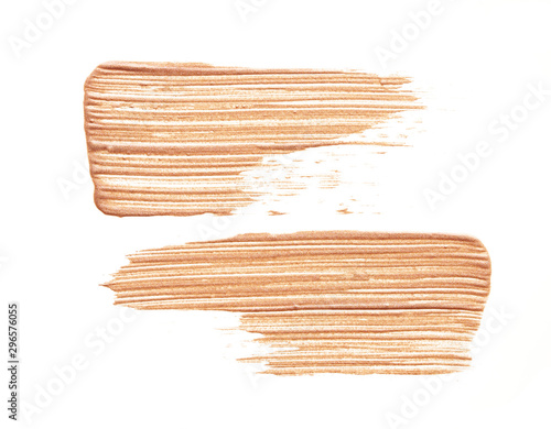 Soft gold texture and strokes of face highlighter or acrylic paint isolated on white background