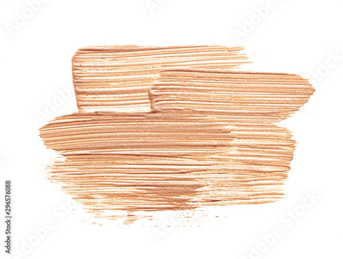 Soft gold texture and strokes of face highlighter or acrylic paint isolated on white background