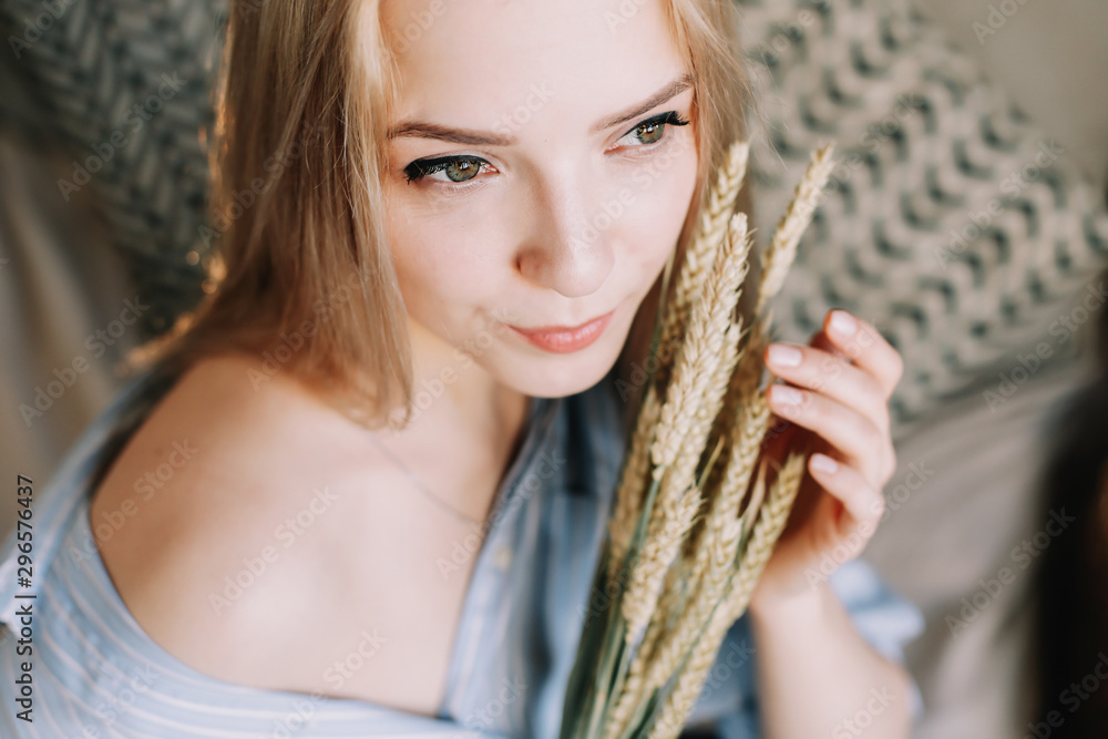 Portrait of a young beautiful woman in bed in the morning at home. Blonde girl in scandinavian interior. Good morning. Lifestyle. Portrait of a young beautiful woman in bed in the morning at home. Blonde girl in scandinavian interior. Good morning. Lifestyle.