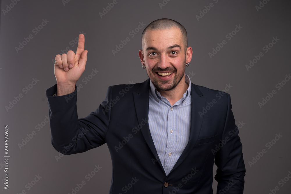 Enthusiastic man pointing upwards with her index finger Enthusiastic man pointing upwards with her index finger