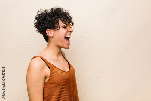 Young african american woman with skin birth mark shouting towards a copy space