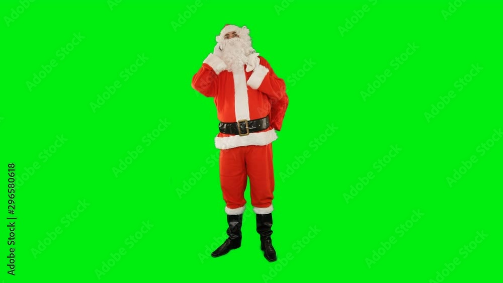 Santa Claus talking on mobile phone with bag filled with presents at his feet, Green Screen Chromakey Santa Claus talking on mobile phone with bag filled with presents at his feet, Green Screen Chromakey
