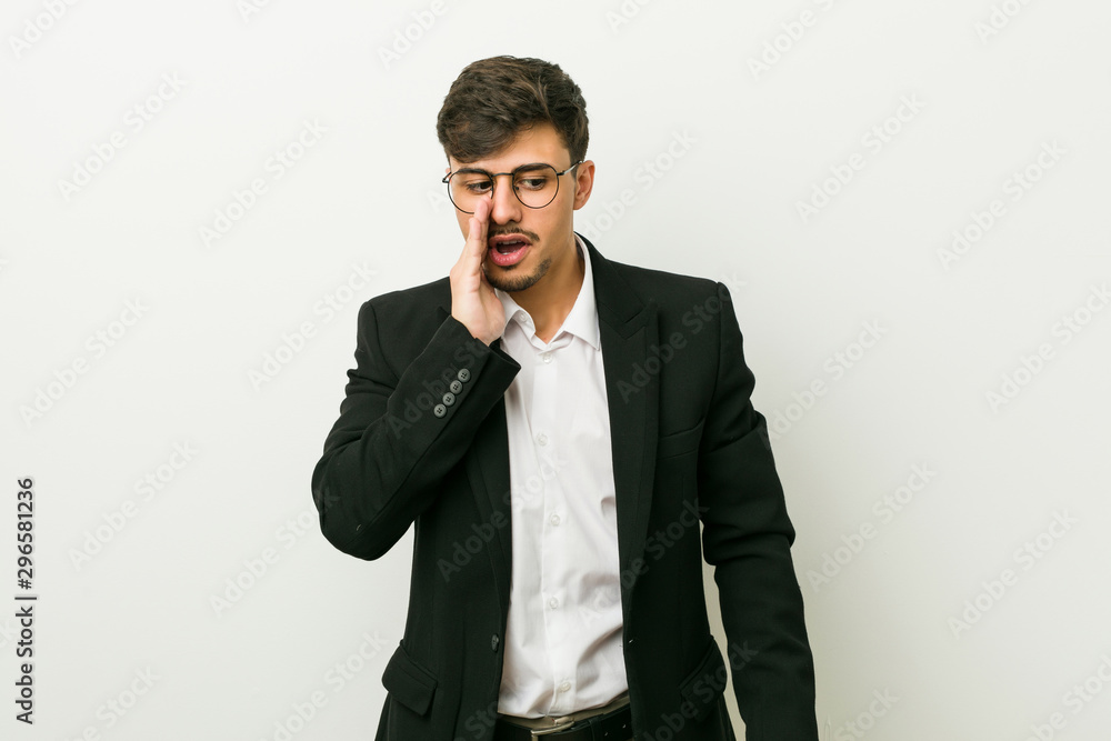 Young business hispanic man is saying a secret hot braking news and looking aside Young business hispanic man is saying a secret hot braking news and looking aside