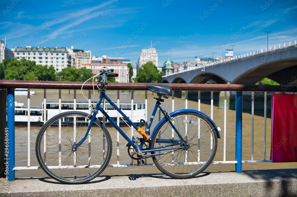 Fototapeta premium Parked bike along River Thames in London, summer season